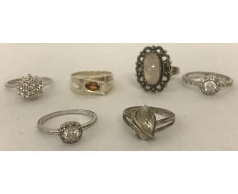 6 silver and white metal dress rings.To include Cubic zirconia cluster  and agate set.Sizes K, O, P, Q and T 1/2.