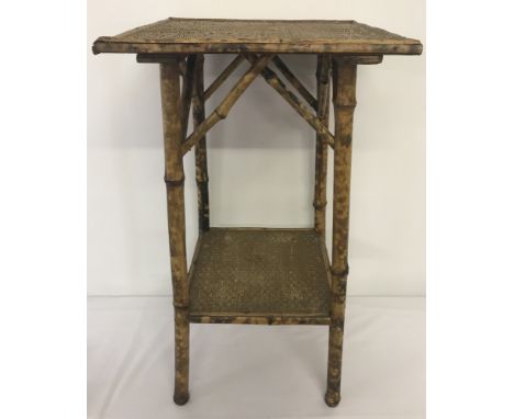 A small vintage bamboo side table with shelf.Approx. 66cm tall.