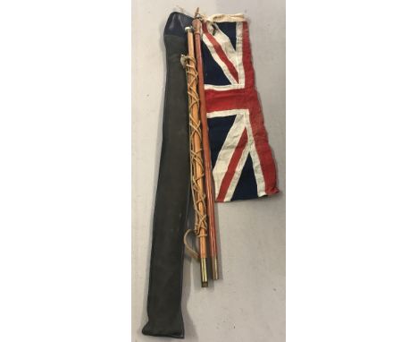 A vintage cased scouts flagpole together with leather carrying strap and 1yd Union Jack flag.