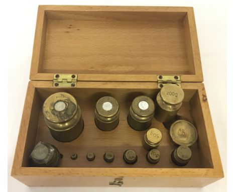 A light wood box containing a quantity of brass weights to include Avery.