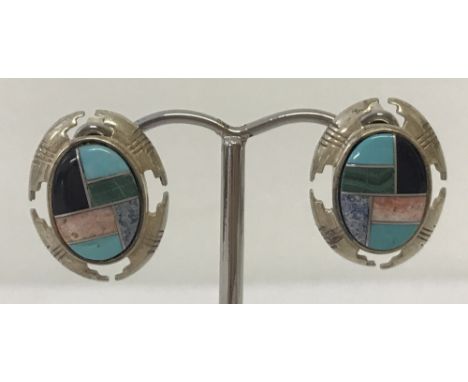 A pair of Southwestern silver and natural stone large stud style earrings by Carolyn Pollock.