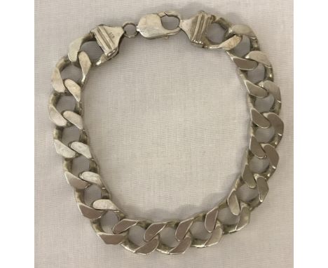 A heavy curb chain bracelet marked 925.Claps and fixing marked 925. Both fixings marked Italy and 925 and scales mark to one 