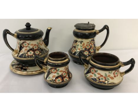 A Victorian ceramic lustreware tea set  with hand painted floral design and gilt detail.Comprising: tea pot, milk jug, 2 hand