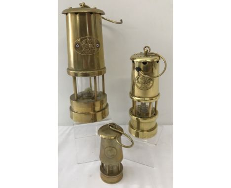 3 vintage brass Welsh miners lamps of differing sizes, each with "Cymru" and Welsh Dragon plate.Largest approx. 23cm standing