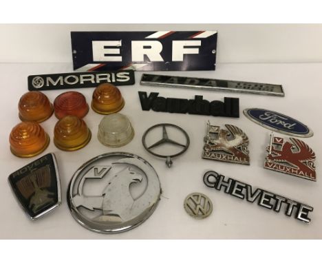 A collection of 12 vintage car badges together with 6 light glasses to include Lucas and Butlers.Car badges to include: Merce