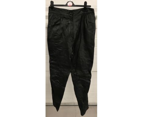 A pair of vintage tapered leg black leather trousers.Zip and button fastening.Size 14-16.