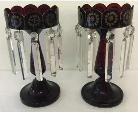 A pair of Victorian Cranberry/Ruby coloured glass lustres.With prism shaped drops (some a/f), gilt paintwork is worn.Approx. 