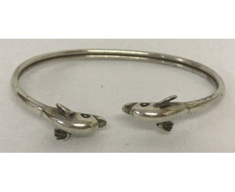 A 925 silver bangle with dolphin head detail.Total weight approx. 12g.