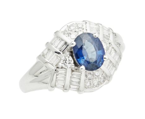 A sapphire and diamond set ring  the oval mixed cut sapphire flanked by round brilliant cut diamonds, raised above pavé set d