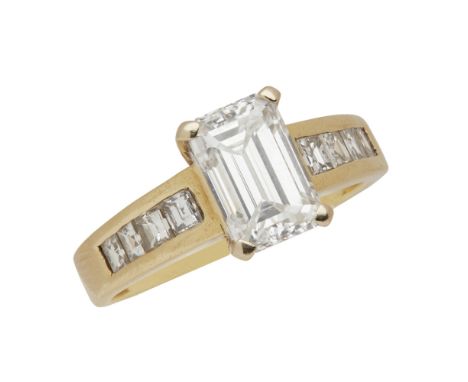 A diamond set solitaire ring  claw set with a single emerald cut diamond, each shoulder channel set with four square step cut