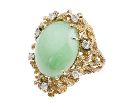 A jade and diamond set cocktail ring  set with an oval cabochon jade within a textured vine-like gold mount claw-set with sev