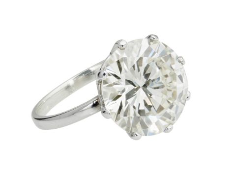 A single stone diamond ring  claw set with a single round brilliant cut diamond, to a plain white metal shank, unmarked; with