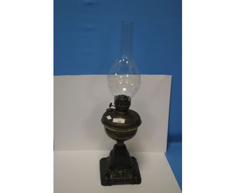 AN BRASS ANTIQUE OIL LAMP WITH CAST IRON BASE