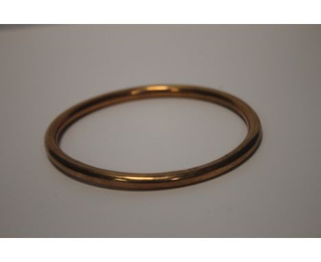 A 9 CT GOLD HOLLOW BANGLE, diam. 8 cm, W 7.2g There are a few small dents and it is slightly bent, otherwise is in generally 
