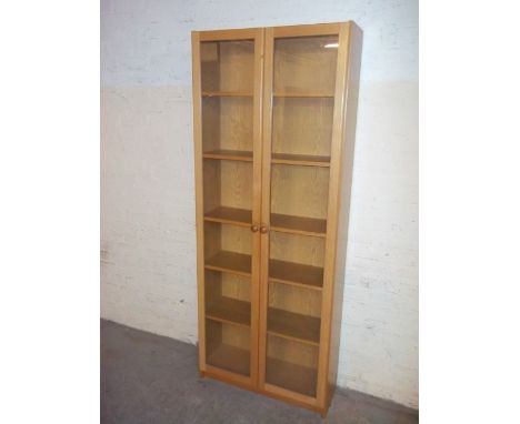 A LIGHT OAK FINISH GLAZED DISPLAY BOOKCASE