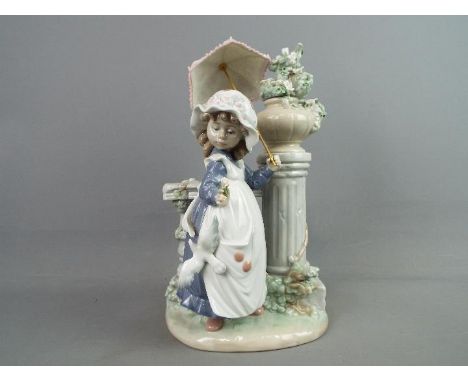 Lladro - A Lladro figural group entitled 'Glorious Spring', depicting a young girl with parasol standing next to a pillar, ap
