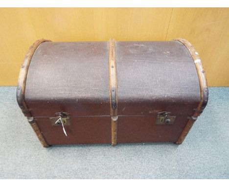 A vintage dome top, wood bound shipping trunk, approximately 50 cm x 77 cm x 50 cm.