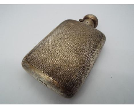 A George V hallmarked silver hip flask with engine turned decoration, Birmingham assay 1920, makers mark for Mappin and Webb,