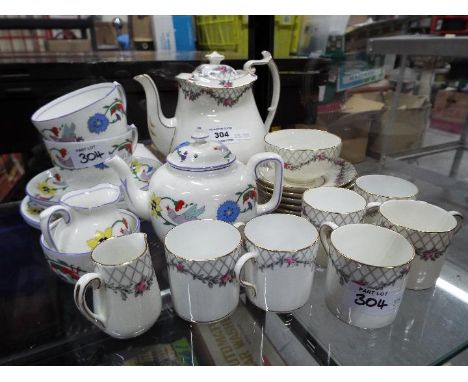 A vintage Paragon China coffee service in the Rose Garden pattern comprising coffee pot, six coffee cans and saucers, sucrier