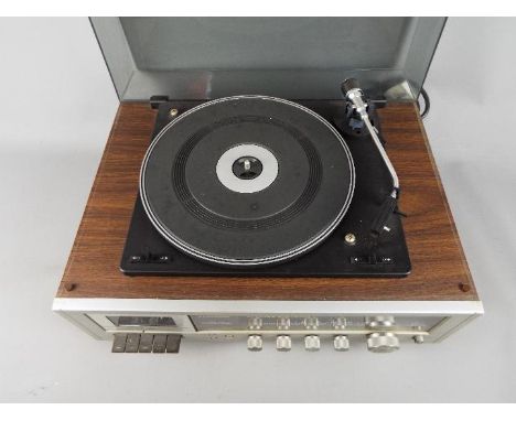 A vintage Lloytron stereo cassette recorder with turntable, model R820, approximately 23 cm x 48 cm x 36 cm.
