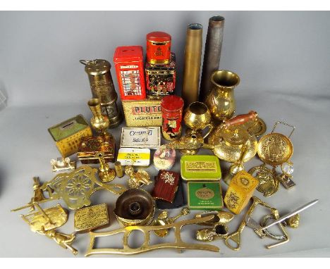 A collection of brassware, shell casings, miner's safety lamp, vintage tins and other.