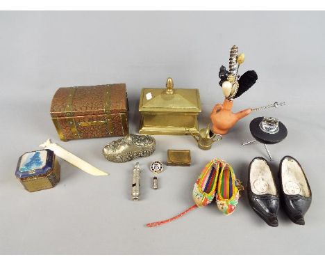 A mixed lot of collectables to include 'The Metropolitan' whistle, enamelled pin badge, hat pins, cigarette lighter, copper b