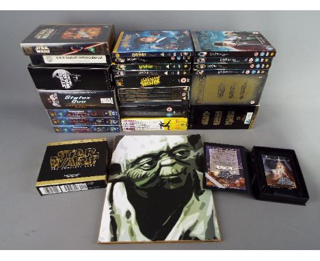 A quantity of DVD's and videos to include, Star Wars, Lord of the Rings, Harry Potter and others, also includes a print of Yo