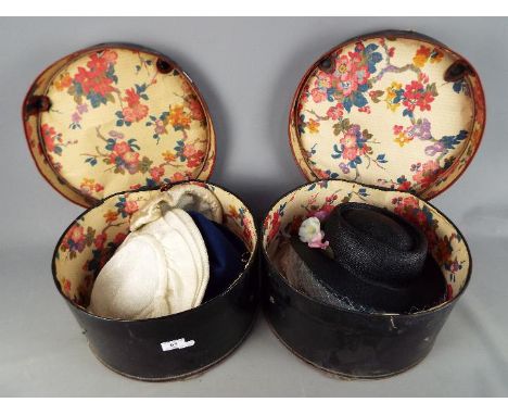 Two vintage hat boxes containing a quantity of lady's hats. [2]