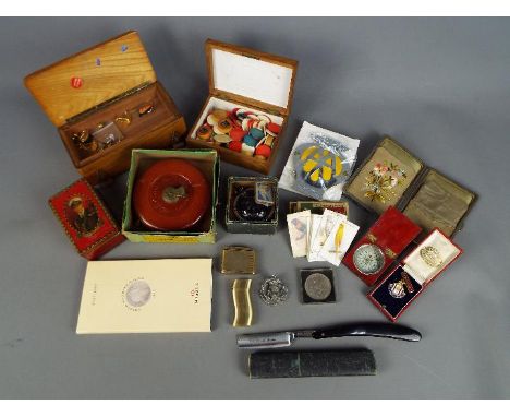 A mixed lot of collectables to include trinket boxes, gaming tokens, cigarette lighters, commemorative crowns, cut throat raz
