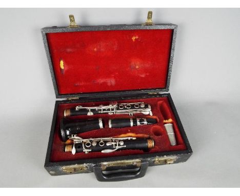 A Besson clarinet, cased, serial number 177584.Condition Report: No cracks to the body, sections fit together tightly, one ke