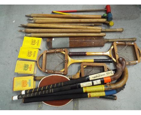A collection of vintage sporting equipment to include tennis rackets, cricket bats including a Jack Sharp, Liverpool example 