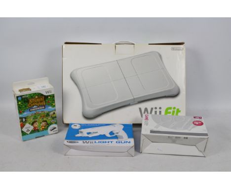 Nintendo - A boxed Wii Fit Board with some boxed accessories, Sports Pack, Wii Speak and Light Gun Adapter. The items show si