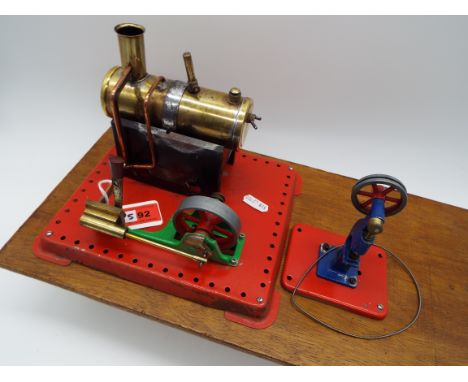 Mamod - a stationary live steam engine and a model power press, both mounted on a wooden base, generally good condition, unbo
