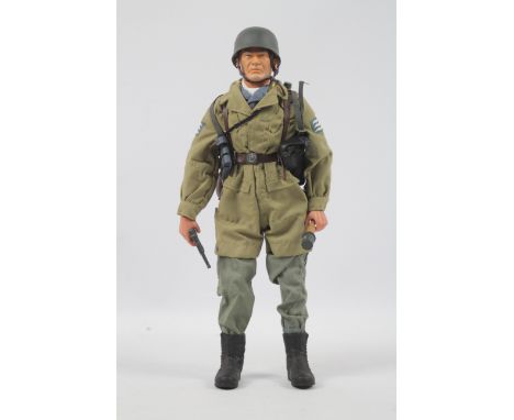 A 1:6 scale German Paratrooper Action Figure attributed to Dragon/DiD. The side of the figure's gun - which is attached to th