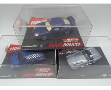 Ninco - three 1:32 scale model slot racing cars, blue Citroen Saxo # 50272, blue Porsche 911 GT3 # 50234, and AC Cobra #50195