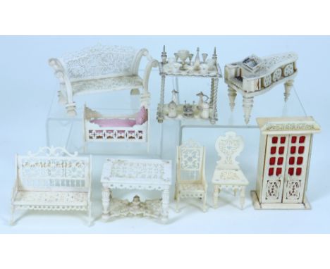 Set of carved bone dolls house furniture, mid 19th century, all with fine pierced fretwork including cupboard with hinged doo