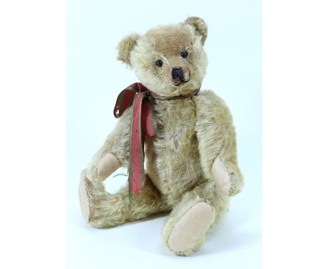 An early Farnell blonde mohair Teddy bear, circa 1920, straw filled bear with black boot button eyes, shaved muzzle with stit