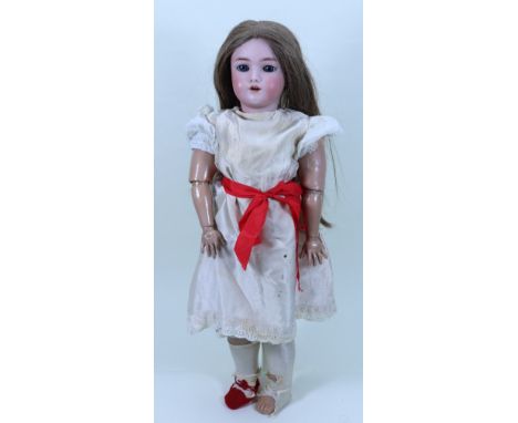 A Heinrich Handwerck/ S&H bisque head doll, German circa 1910, with weighted blue glass eyes, open mouth, replaced upper teet