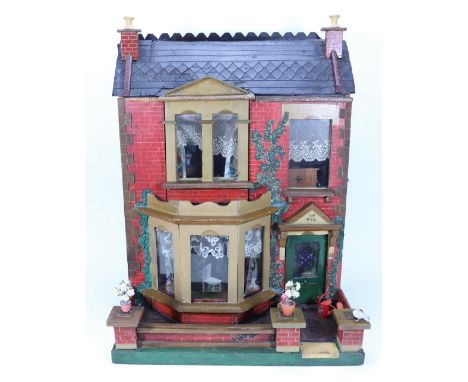 ‘Ivy Villa’  a painted wooden dolls house and contents, English circa 1890, the red brick effect façade with painted green iv