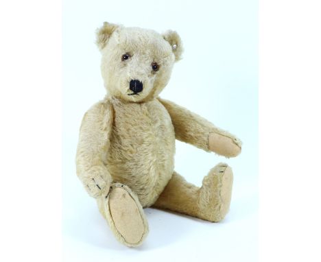 A good Steiff post-war golden mohair Teddy bear, with brown glass eyes, stitched nose and mouth, swivel head and jointed at s