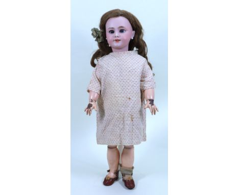 A DEP bisque head doll, German for French market, circa 1900, with weighted blue glass eyes, painted eyelashes and raised eye