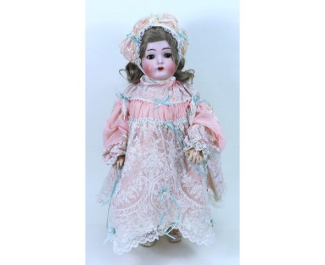 A Kammer & Reinhardt/S&H 403 bisque head ‘walker’ doll, German circa 1905, with weighted brown glass eyes, raised eyebrows, o