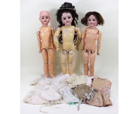 Three bisque head dolls and clothes, German circa 1910, including a Handwerck 119 with open mouth, upper teeth and pierced ea