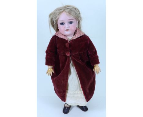 A bisque head girl doll, German circa 1910, with weighted blue glass eyes, open mouth, teeth,  long light brown wig, on a ful