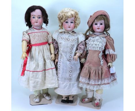 A.M ‘Floradora’ bisque head girl doll and two others, German circa 1915, with weighted blue glass eyes, open mouth, upper tee