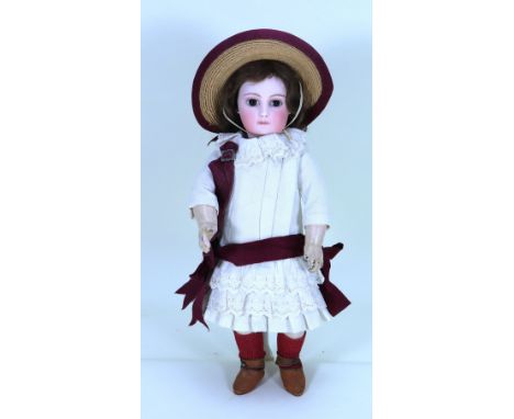 A good early portrait Jumeau bisque head Bebe doll, size 2, French circa 1880, the pale bisque head with fixed brown glass pa