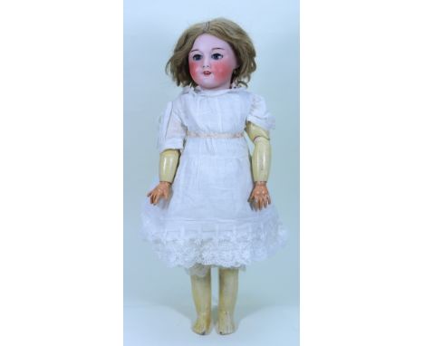 An S.F.B.J 301 bisque head mechanical ‘walker’ doll, French circa 1910, with weighted blue glass eyes, open mouth, upper teet