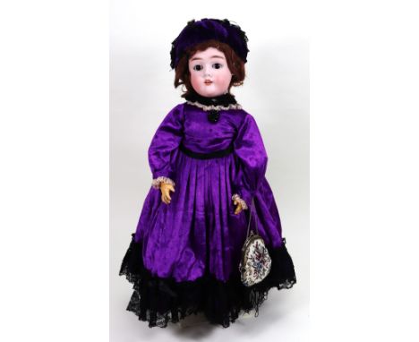 A Max Heinrich Handwerck bisque head girl doll, German circa 1905, with weighted brown glass eyes, open mouth with upper teet