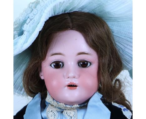 A Kammer & Reinhardt/S&H bisque head girl doll, German circa 1905, with weighted brown glass eyes, real lashes and raised eye