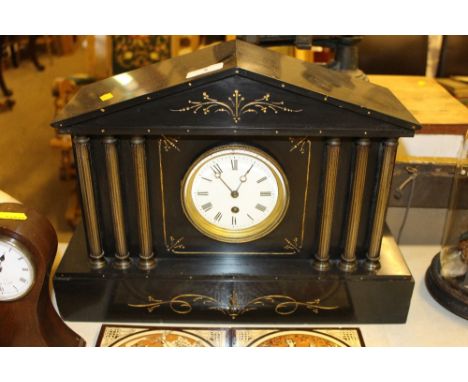 A late Victorian black slate single hole mantel clock of architectural form